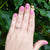 pink gemstone solitaire ring on hand