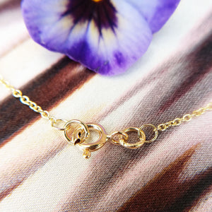 gold necklace secured by spring ring clasp