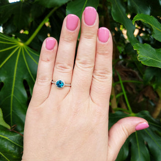 topaz and diamond cluster ring on hand