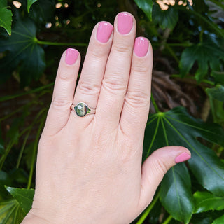 silver signet ring on hand