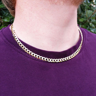 gold curb chain on man's neck