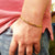 gold curb bracelet on wrist