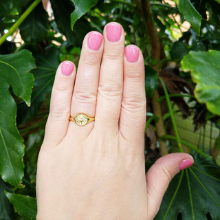 women's round signet ring on hand