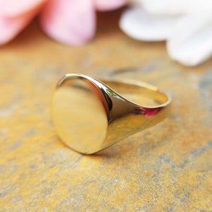close up of women's gold signet ring