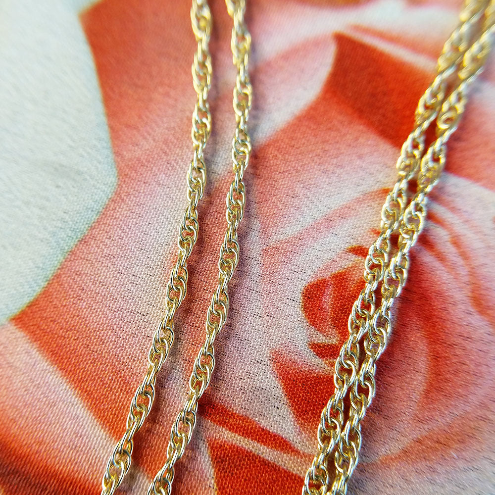 close up of gold prince of wales links