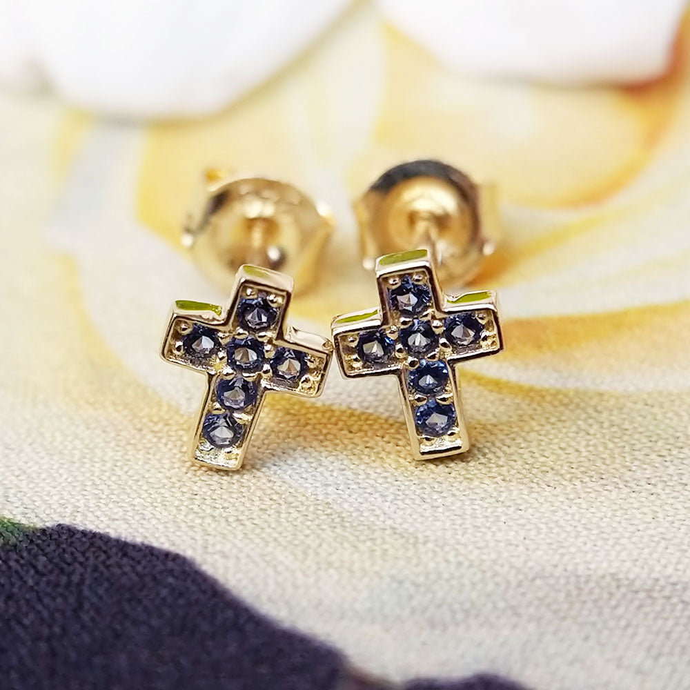 close up of sapphire cross stud earrings