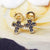 close up of sapphire cross stud earrings