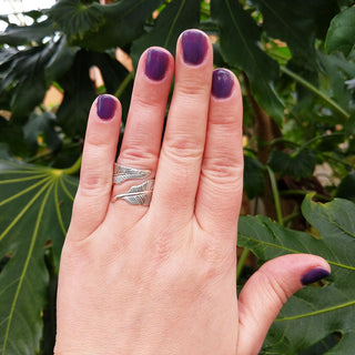 silver feather ring on hand