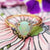 close up image of opal and diamond cluster ring
