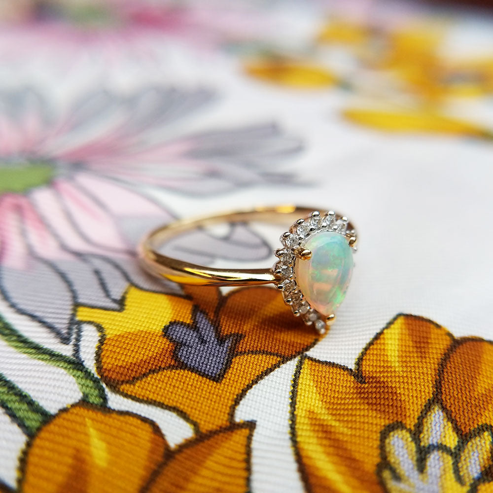 gold ring set with pear shaped opal and diamonds