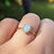 close up of opal ring on finger
