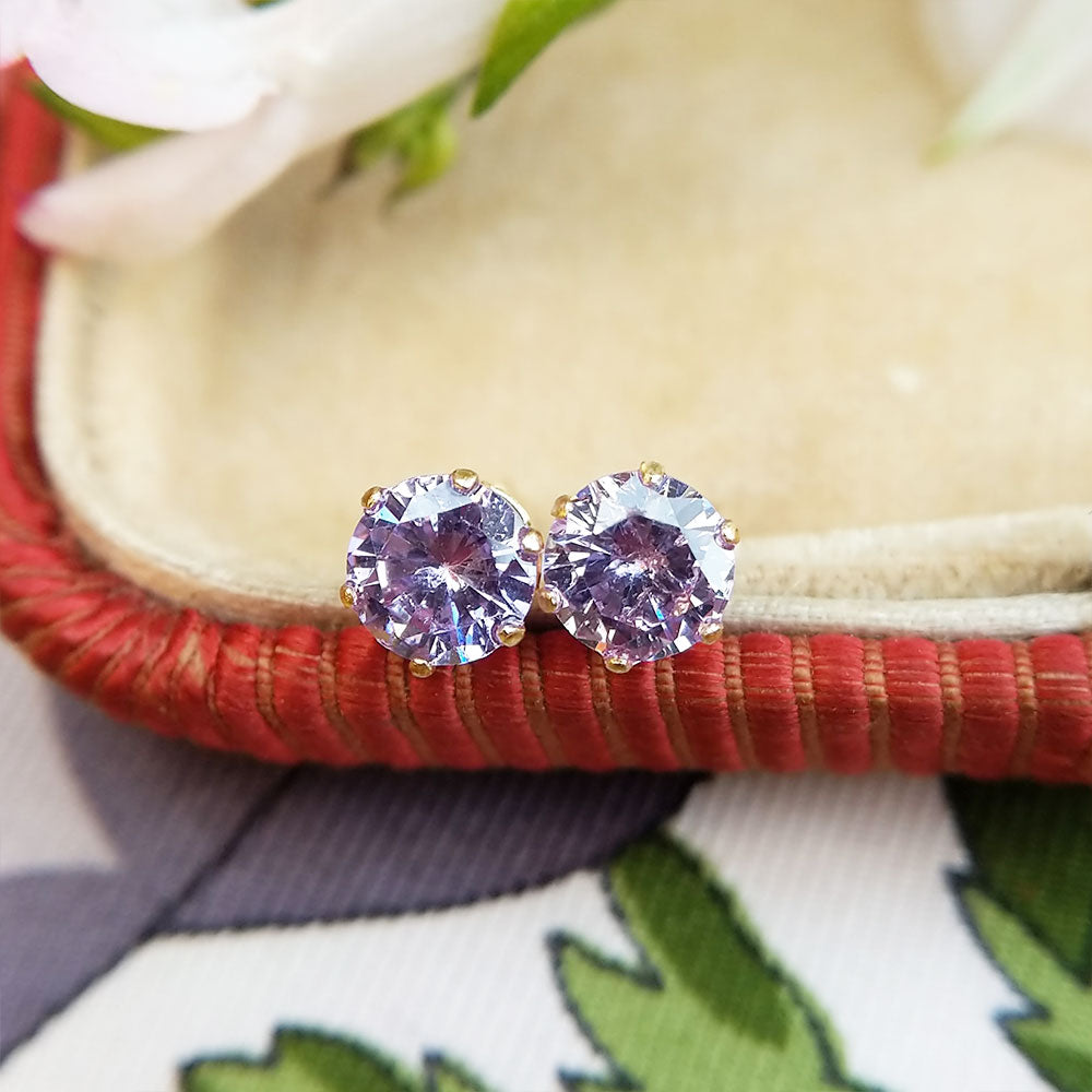 close up of purple stud earrings