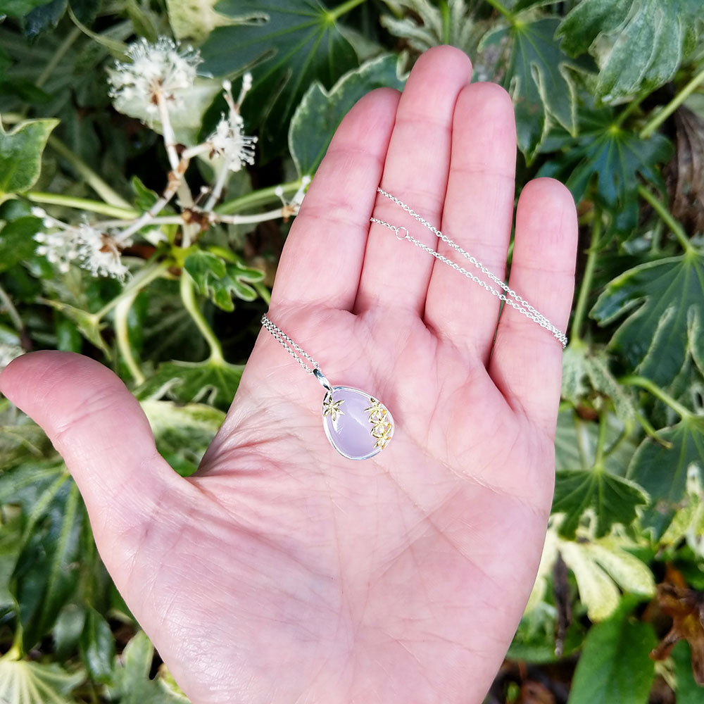 necklace in hand for scale