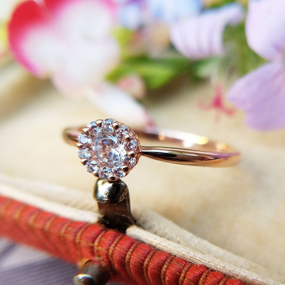 rose gold ring set with clear, sparkling zirconia stone