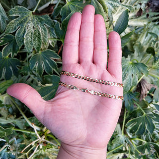 gold curb chain in hand for scale