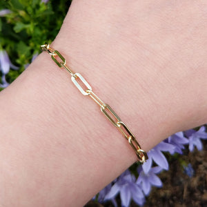 gold paper clip bracelet on wrist