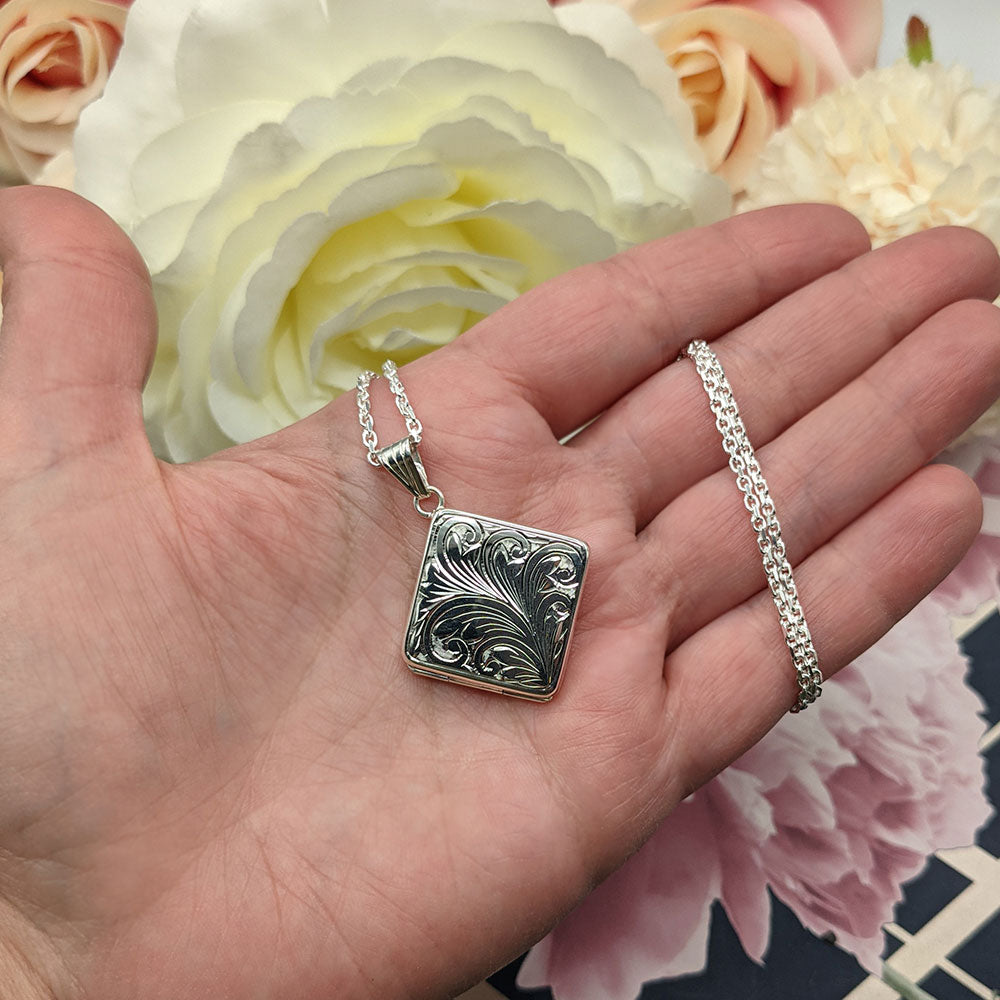 solid silver locket in hand for scale