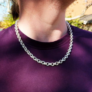 chunky silver belcher chain on man's neck