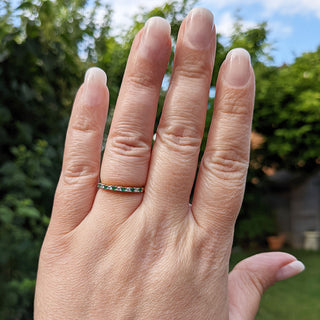 emerald eternity ring on hand