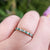 skinny emerald diamond ring on finger