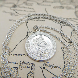 embossed st christopher design on front of pendant