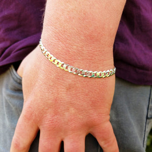 silver curb bracelet on man's wrist