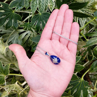 egg pendant in hand for scale