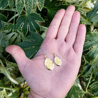 medals in hand for scale