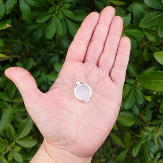 silver locket in hand for scale