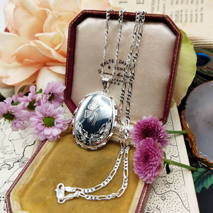 locket engraved with a butterfly and flowers design