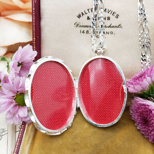 inside large silver locket is room for two photos of loved ones