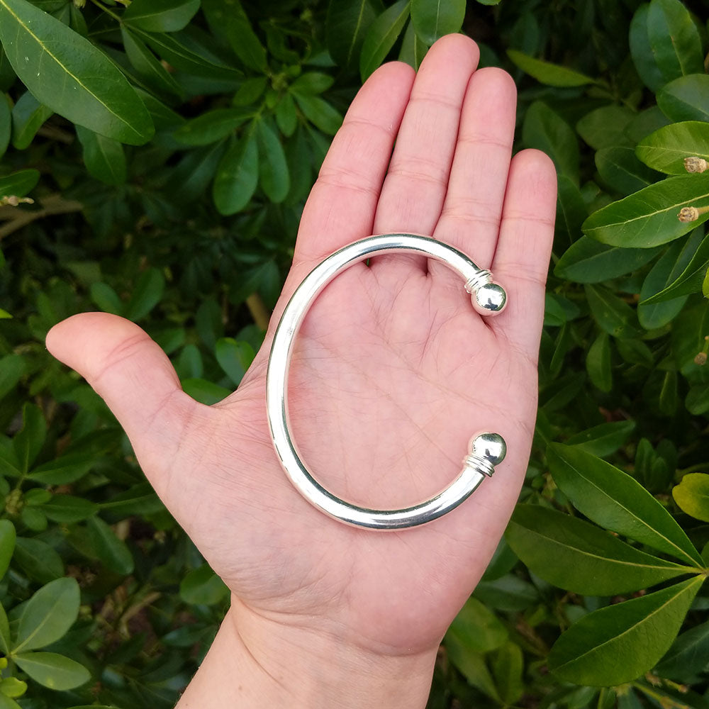 men's bangle in hand for scale
