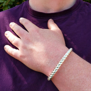 men's silver twist Celtic bangle on wrist