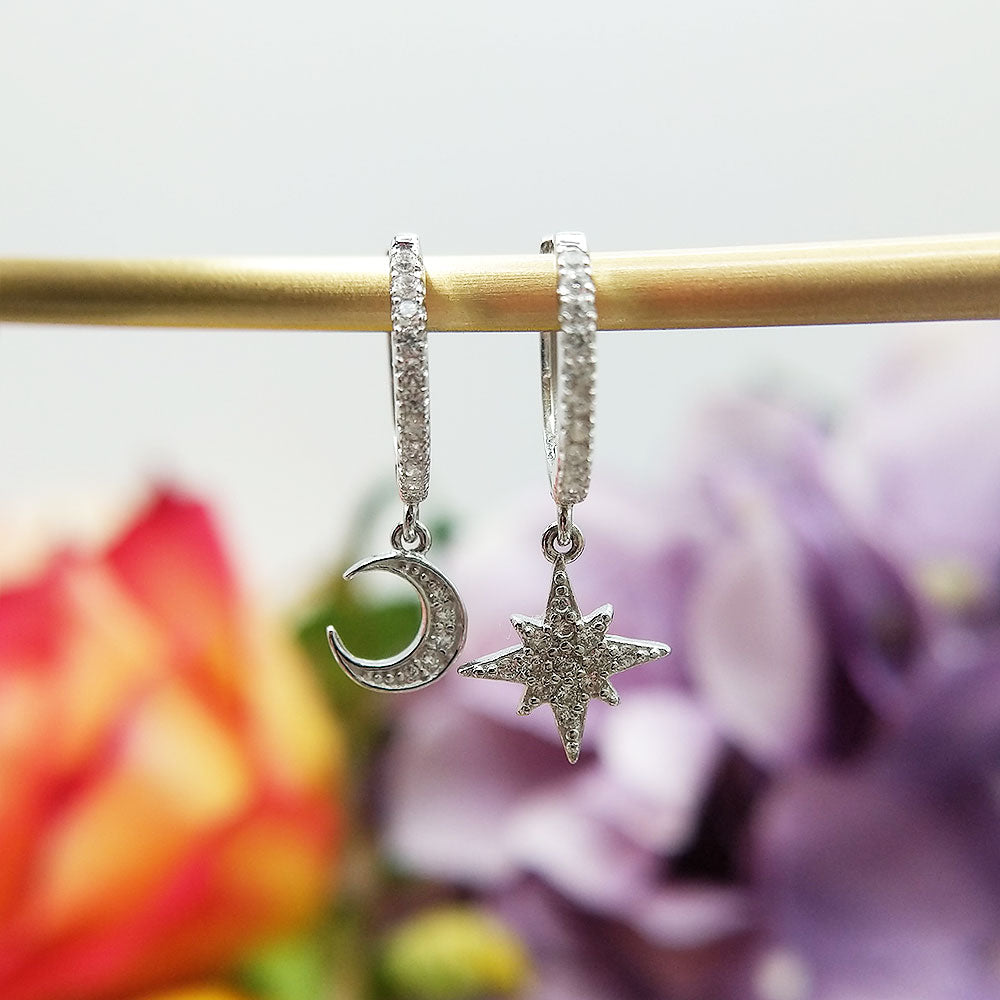 sterling silver charm huggie earrings with moon and star