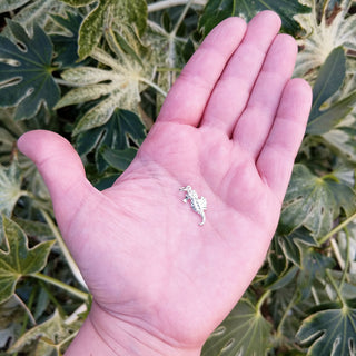 seahorse necklace in hand for scale