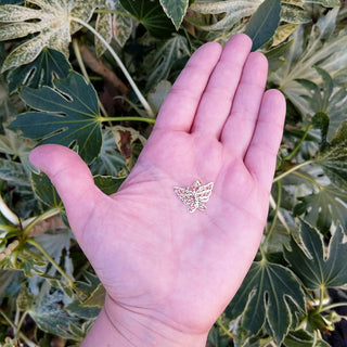 butterfly pendant in hand for scale