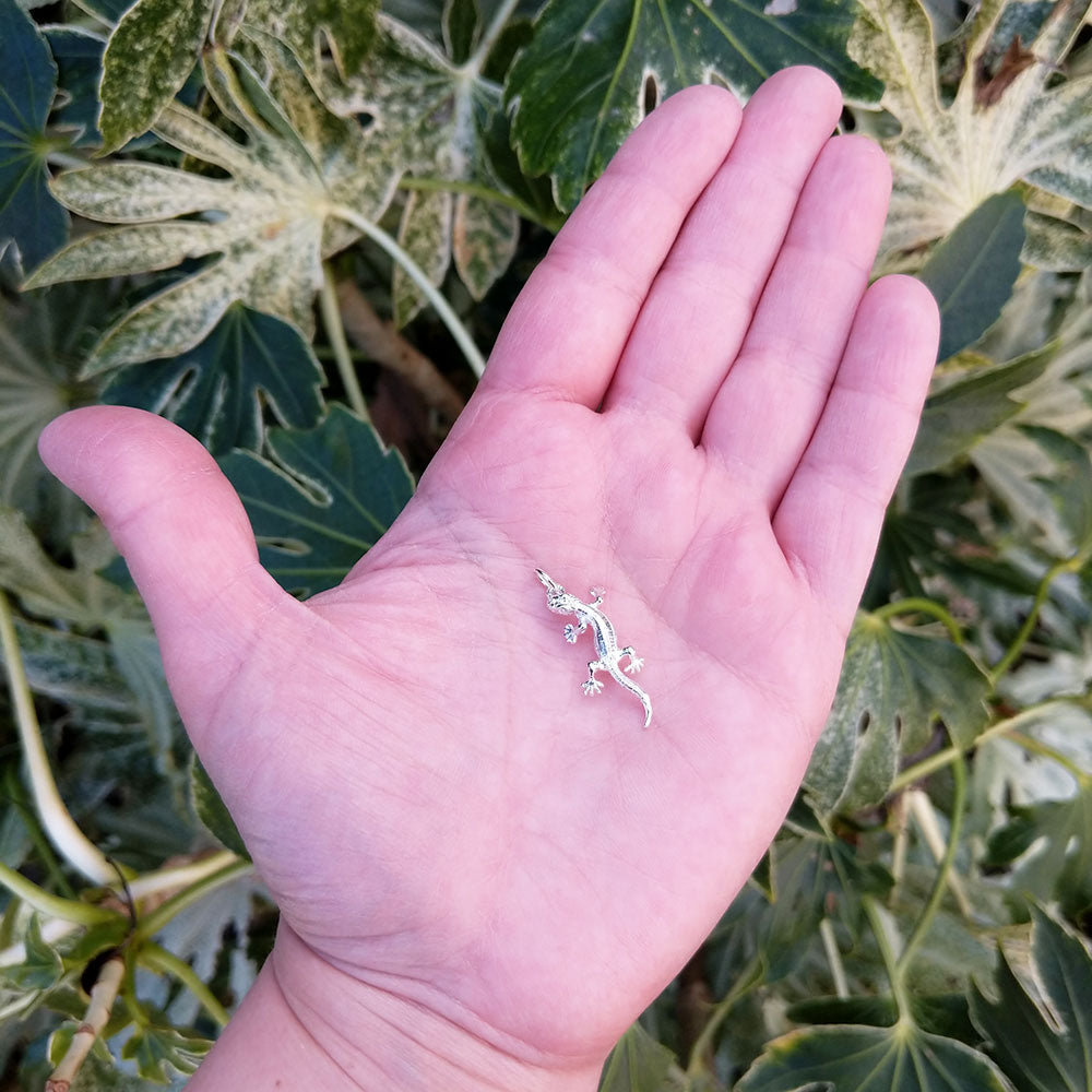 lizard charm in hand for scale