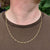 gold singapore twist curb chain on man's neck