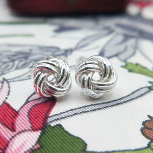 close up of silver knot studs