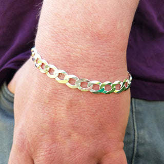 silver curb bracelet on man's wrist