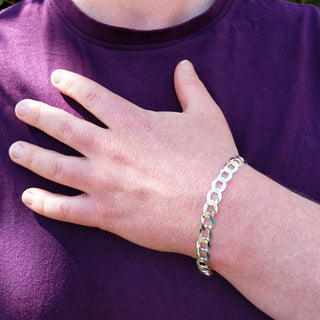 silver curb bracelet on man's wrist