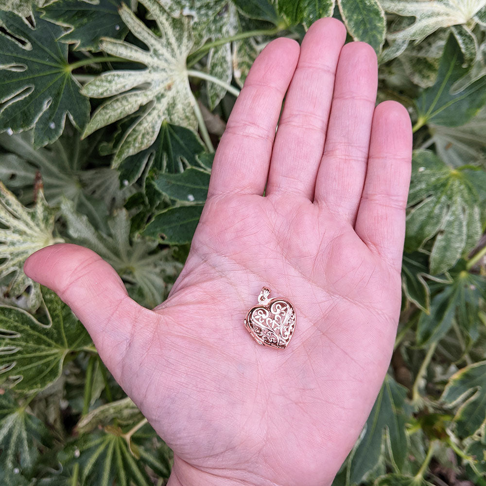 rose gold locket in hand for scale