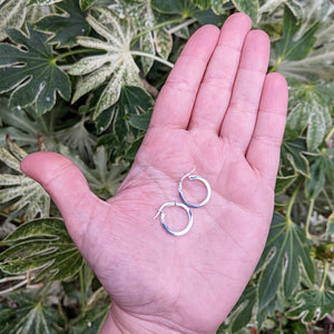 small white gold hoops in hand for scale