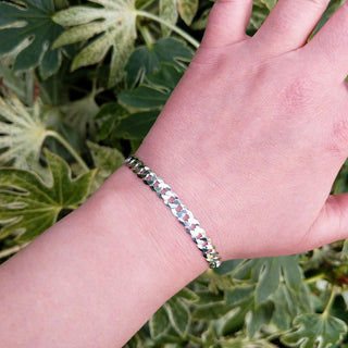 silver curb bracelet on woman's wrist