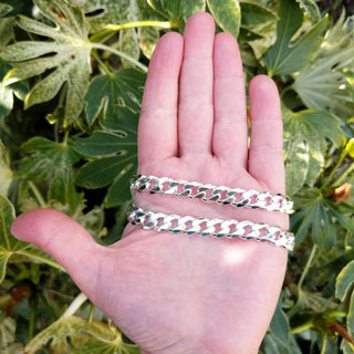 men's 9mm silver chain in hand for scale