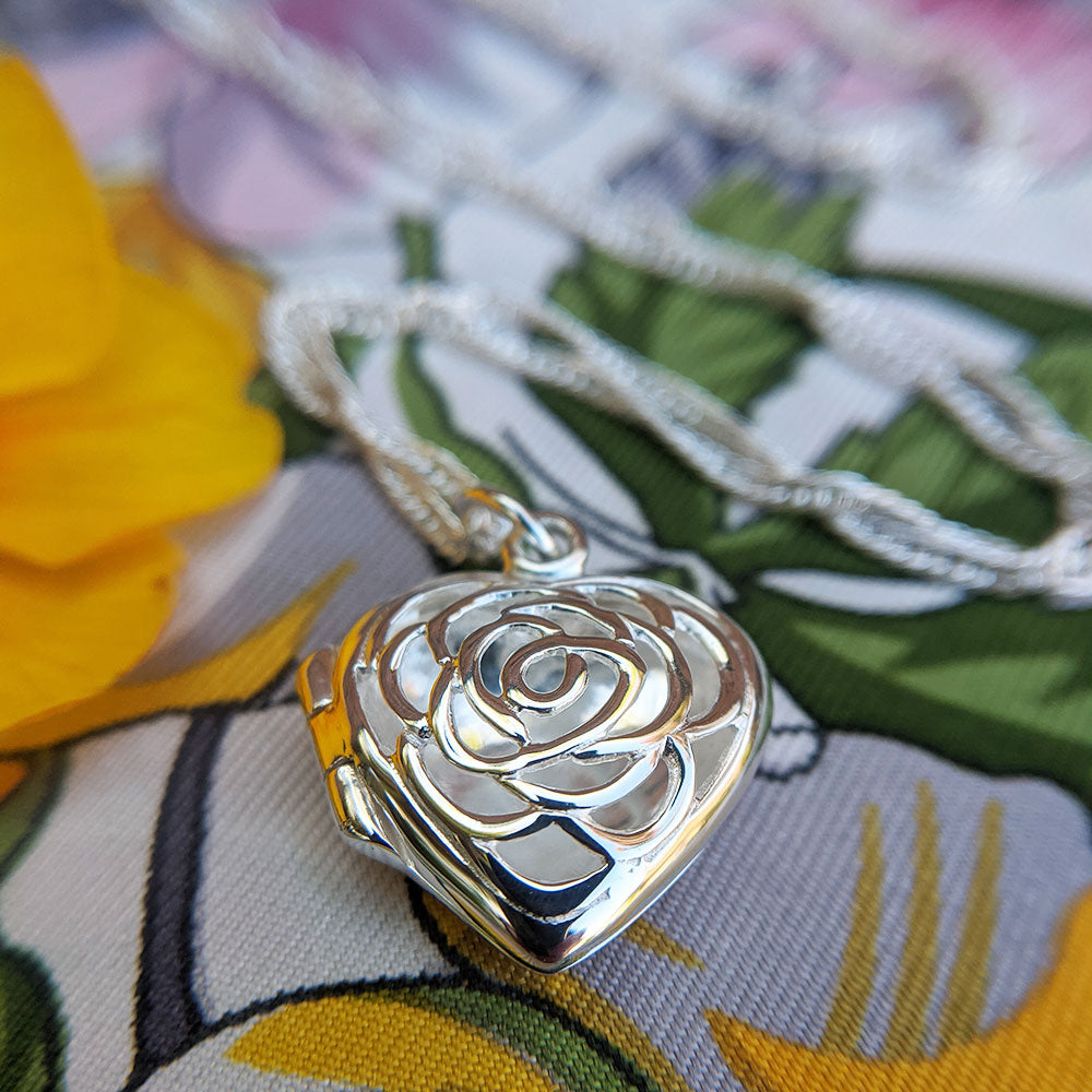 close up of rose flower heart locket necklace