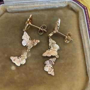 butterfly dangle earrings secured to the ear with a post fitting