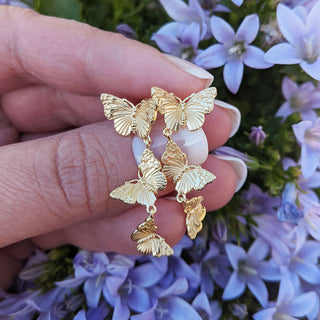 butterfly dangle earrings in hand