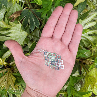 sterling silver earrings in hand for scale