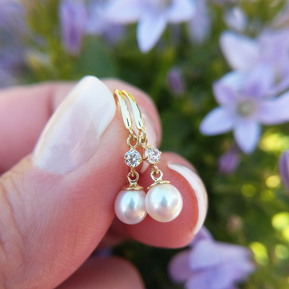 close up of cz and pearl drop earrings